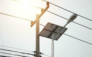 Street lighting pole with photovoltaic panel and LED lamp lights photo