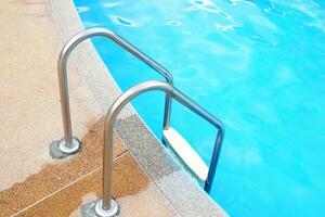 Stainless steel swimming pool railing is used for holding up and down the swimming pool for safety, strength, made from corrosion resistant materials, not rusty, not slippery. photo