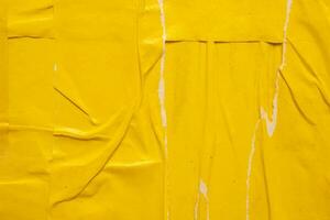 Old grunge ripped torn yellow paper poster surface texture background photo