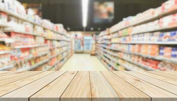 Empty wood table top with supermarket blurred background for product display photo
