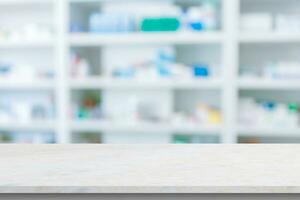 Empty white counter with pharmacy drugstore shelves blurred background photo