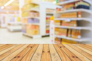 Empty wood table top with supermarket blurred background for product display photo