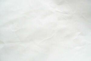 Abstract white crumpled and creased recycle paper texture background photo