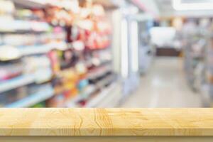 Empty wood table top with supermarket blurred background for product display photo