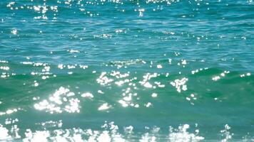 Azure shiny sea waves, slow motion, blurry glare. Tranquility, relaxation, freedom video