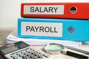 Salary Payroll. Binder data finance report business with graph analysis in office. photo