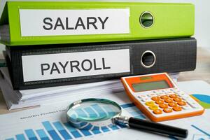 Salary Payroll. Binder data finance report business with graph analysis in office. photo