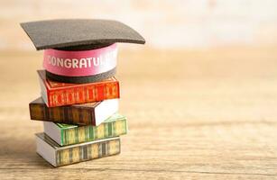 Graduation hat on book with copy space, learning university education concept. photo