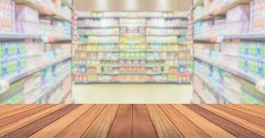 Empty wood table top with supermarket blurred background for product display photo