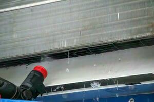 air conditioning cleaning service with water spray photo