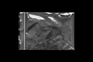 Blank transparent plastic bag overlay on black background photo