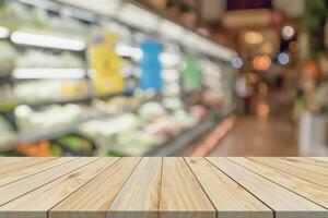 Empty wood table top with supermarket blurred background for product display photo