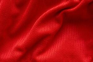 Fondo de textura de jersey de camiseta de fútbol de tela de ropa deportiva roja foto