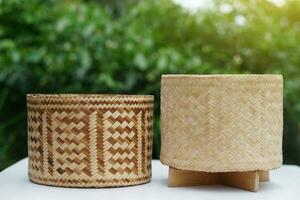 Woven bamboo rice box in cylinder shape for contain sticky rice. Concept , handmade, handicraft. Thai wisdom to use natural materials to be kitchenwares. Safety food with nature  container. photo