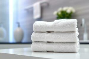 stack of clean white towels on a table with blur background AI Generated photo