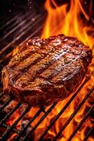 a beef steak is being cooked on a grill with fire flames photo