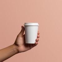 a person holding a paper coffee cup in his hand photo