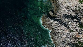 Aerial top down view of rocky sea coast in Sardinia video