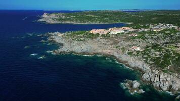 Aerial view of sea coast with blue sea and rocky cliff in Sardinia video