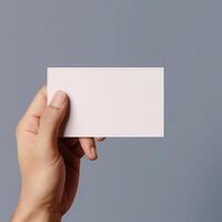 a person holding a business card in his hand photo