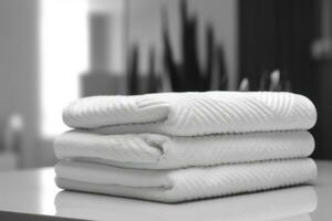stack of clean white towels on a table with blur background AI Generated photo