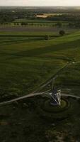 an aerial view of a windmill in the middle of a field video