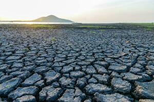 Cracks on the surface of the earth are altered by the shrinkage of mud due to drought conditions of the terrain. photo