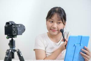 cute asian woman blogger is showing how to make up and use cosmetics. photo