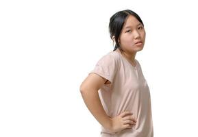 Sad and bored asian girl looking reluctant and unamused at camera, leaning face on hand, standing over white background photo