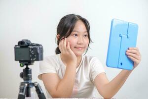 Beauty girl blogger concept, Asian girl llook in the mirror in live streaming on white photo