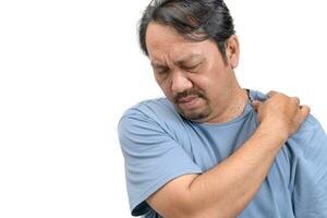 Middle aged man feel neck pain due to working in front of a computer for a long time photo