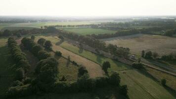 Aerial view of a rural landscape with trees and fields video