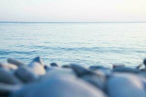 Stones and pebbles on the sea shore. Black Sea. Selective field of focus. Blurred background. photo