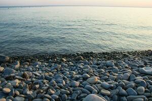 Sea and pebbles underwater in a beach. Pebble background photo