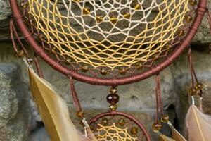 Handmade dream catcher with feathers threads and beads rope hanging photo