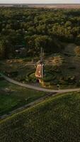 an aerial view of a windmill in the middle of a field video