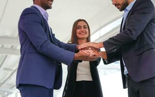 multiracial business people hands stacked for successful business, young happy business teamwork working outside building. selective focus at their hands photo