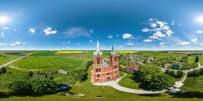 full hdri 360 panorama aerial view on red brick neo gothic catholic church in countryside or village in equirectangular projection with zenith and nadir. VR  AR content photo