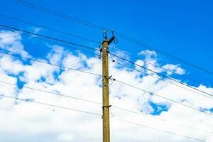 Power electric pole with line wire on colored background close up photo