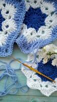 Blue, white crochet elements and orchid. Crochet texture, place for an inscription, adapted for mobile phone photo