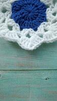 Blue, white crochet elements and orchid. Crochet texture, place for an inscription, adapted for mobile phone photo