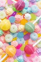 Sweet lollipops and candies on white background photo