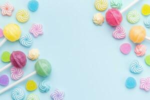 Sweet lollipops and candies on blue background photo