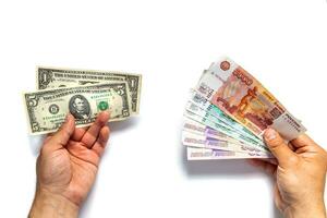 Russian rubles and American dollars in the hands of men on a white background. Financial crisis, ruble devaluation concept. . photo