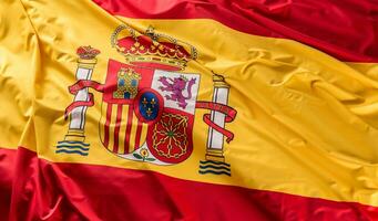 Spain flag of silk. Spanish national colours with emblem photo