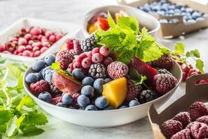 Frozen fruits blueberries blackberry raspberry red currant peach and herbs melissa photo