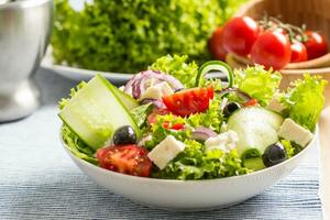 Salad with fresh vegetables olives tomatoes red onion greek cheese feta and olive oil photo