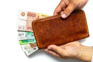 Russian rubles in a wallet in the hands of a man on a white background. Financial crisis, ruble devaluation concept. . photo