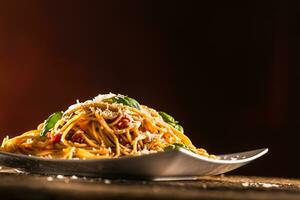 Italian pasta spaghetti with tomato sauce basil and parmesan cheese in white plate photo