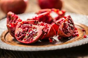 Pomegranate. Pieces of frest pomegranate on plate photo